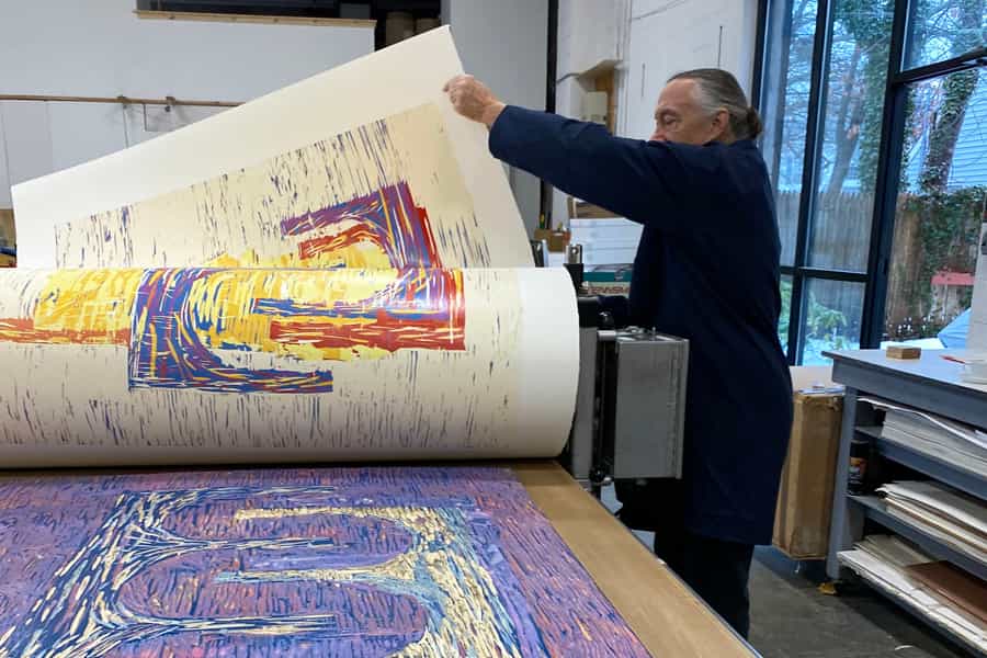 Bruce Wankel printing the wood block.