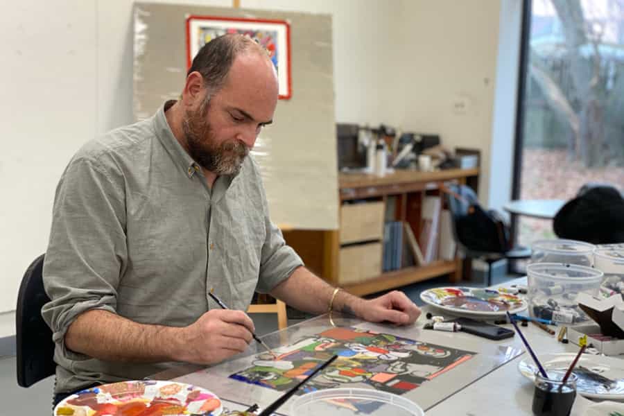 Artist Eddie Martinez painting watercolor on a plate.