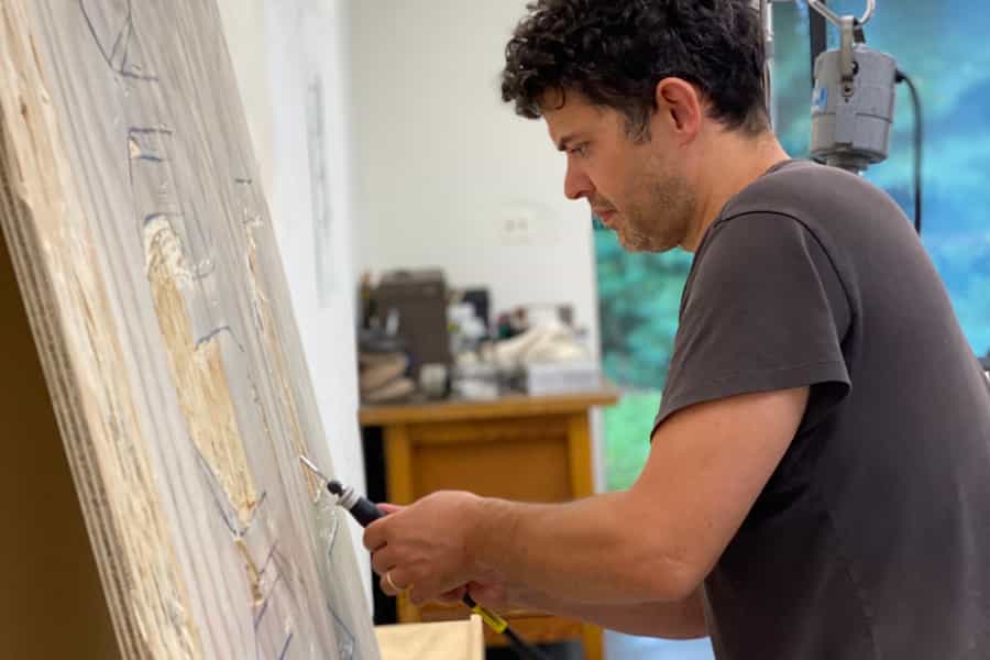 Wyatt Kahn carving a woodblock