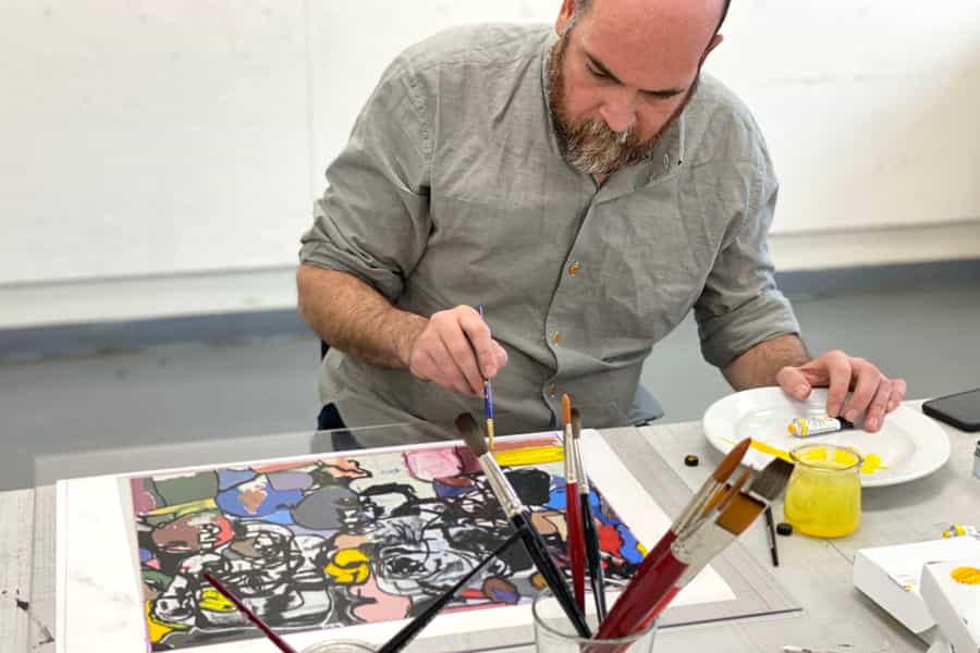 Artist Eddie Martinez painting watercolor on a plate.