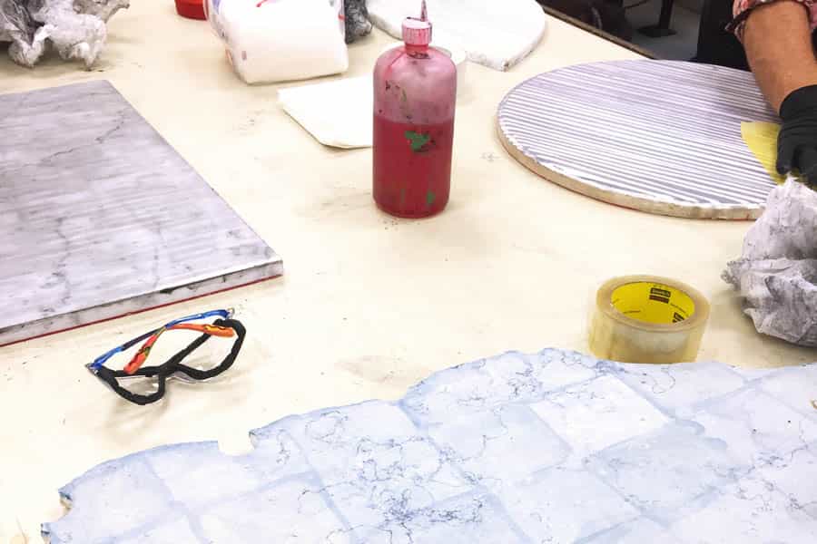 Various stones being etched and prepped to print.