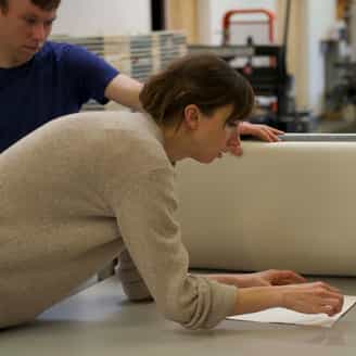 Julia Rommel working on the etching press.