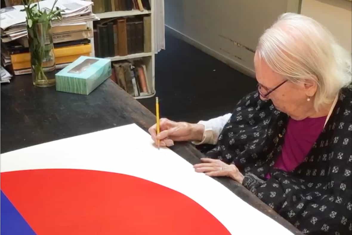 Carmen Herrera signing the edition in her New York City apartment.