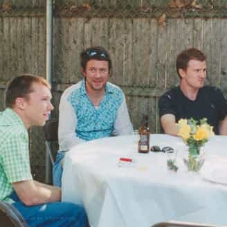 Brian Berry, Joey Kotting, and Doug Bennett sitting at a table in the backyard of the studio at the 45 year anniversary of ULAE.