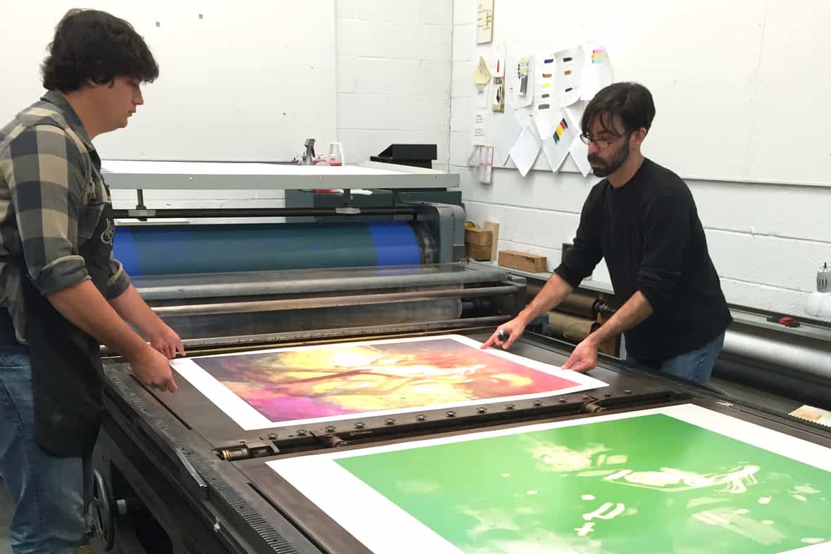 Printers Steven Fournier and Jason Miller printing on the offset litho press for Hippies in Tit Heaven.