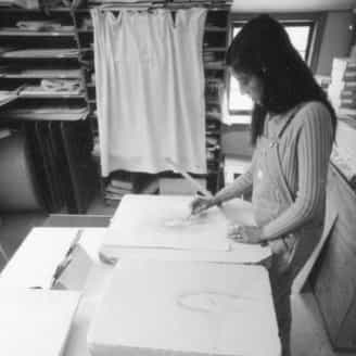 Marisol beginning her work on the print Catalpa Maiden Touching Herself.