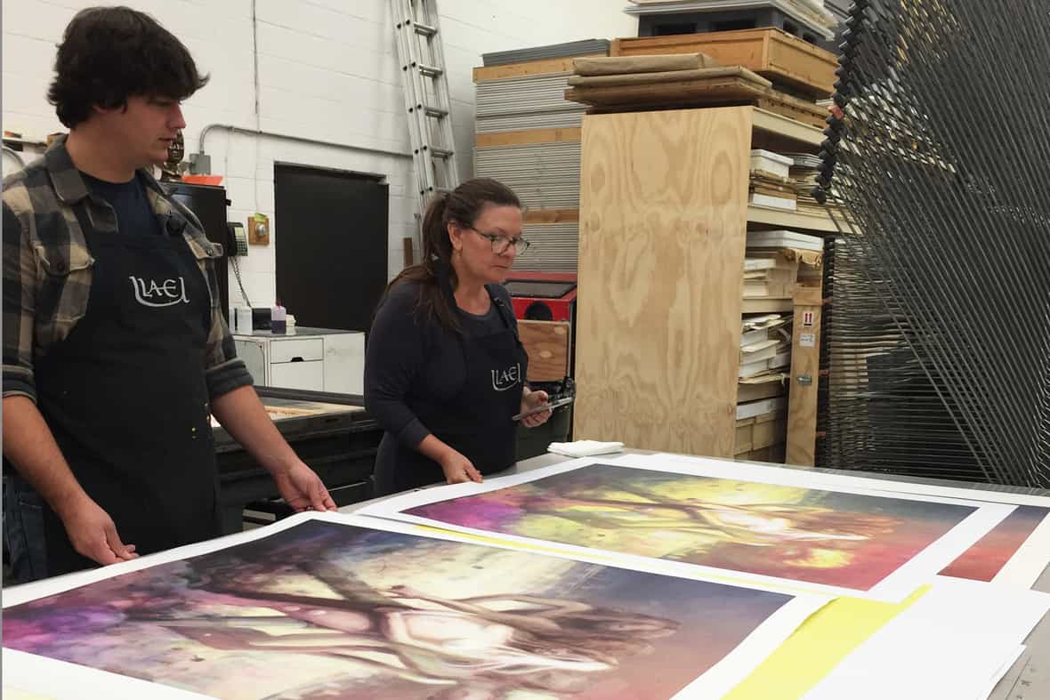 Steven Fournier and Lisa Yuskavage comparing proofs.