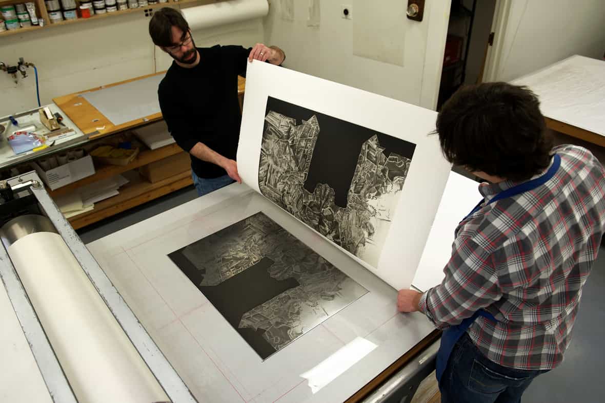 Jason Miller and Steven Fournier printing the etching plate.