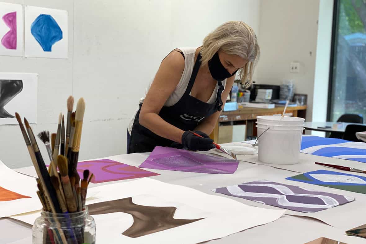 Marina Adams painting monoprints in the studio.