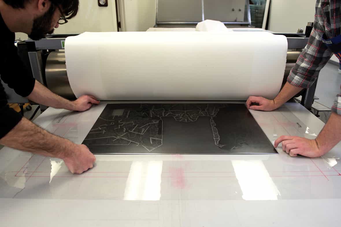 Printmakers Jason Miller and Steven Fournier printing the etching plate for "Regrets" edition of 36.