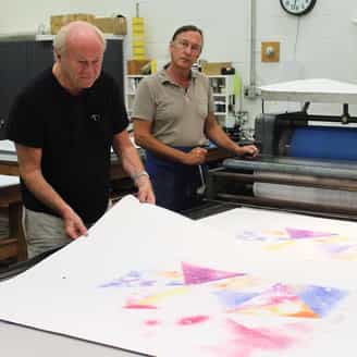 James Rosenquist and Bruce Wankel on the lithography press working on To Infinity.